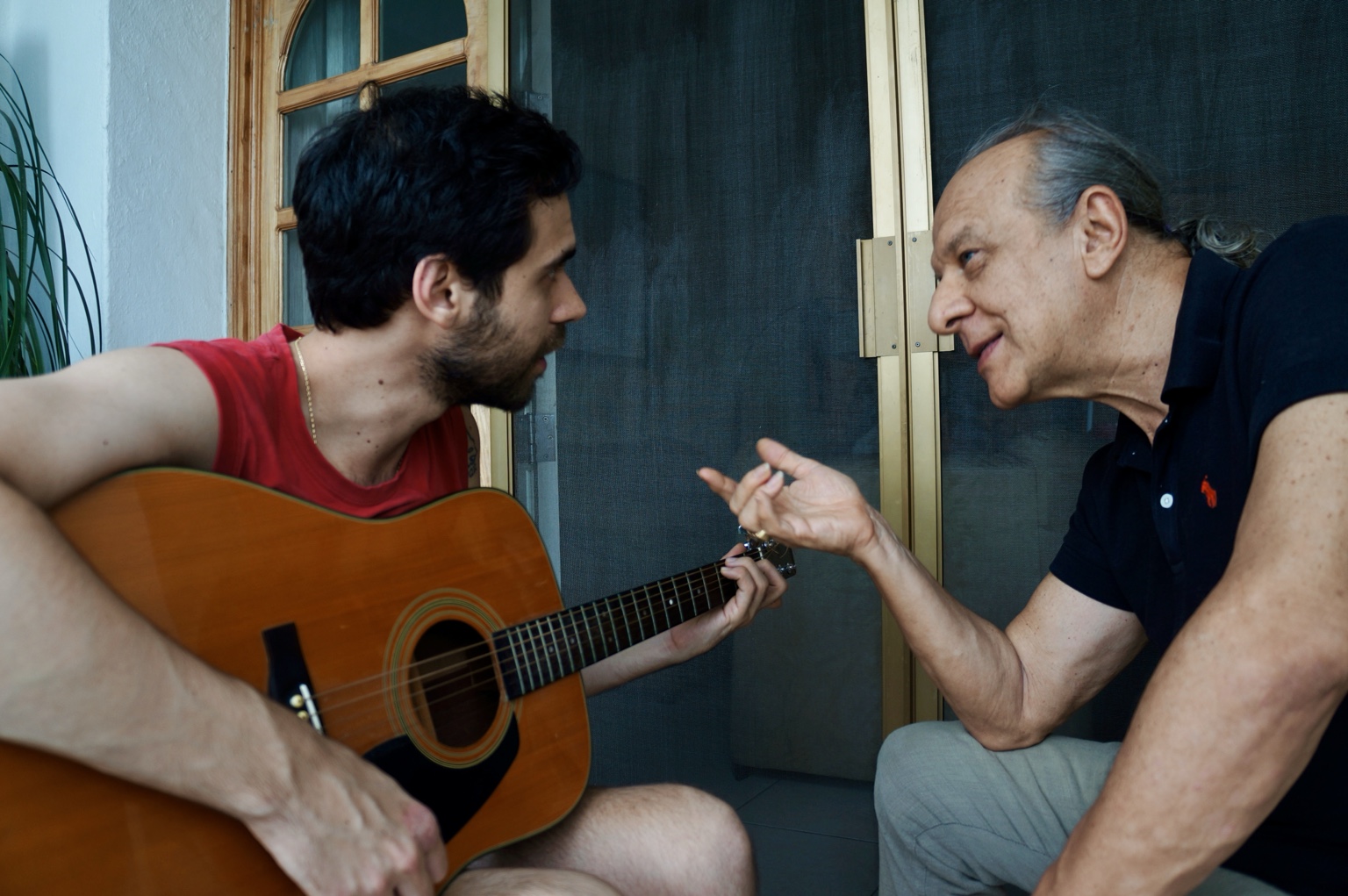 LUPO writing music with guitar